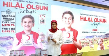 Turkish Red Crescent Deputy Director, Professor Fatma Meriç Yılmaz, shows the cans of meat that will be delivered in the campaign, in Istanbul, Turkey, June 9, 2022.
