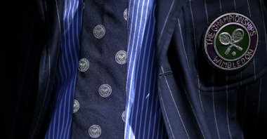 The umpire&#039;s tie and jacket display the logo of the Wimbledon Championships, London, England, July 2, 2018. (AP Photo)