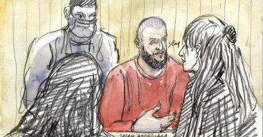 A sketch depicting defendant Salah Abdeslam (C), the prime suspect, standing in front of French lawyer Claire Josserand Schmidt (R) during the trial of the November 2015 terrorist attacks that saw 130 people killed, Palais de Justice courthouse, Paris, France, May 23, 2022. (AFP File Image)