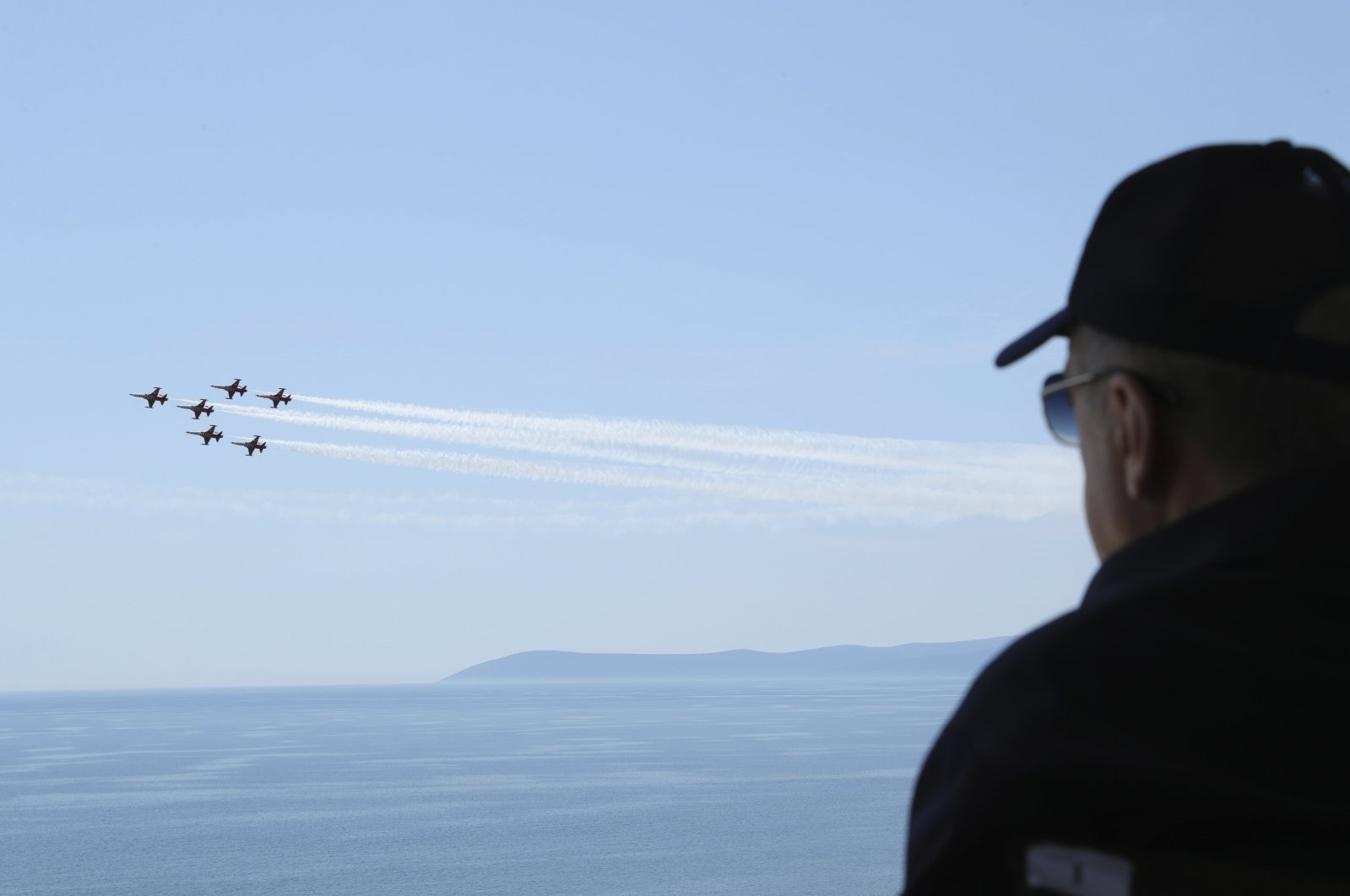 In this handout photo provided by the Turkish Presidency, President Recep Tayyip Erdoğan watches jet fighters fly past during the final day of military exercises in Seferihisar near Izmir, on Turkey&#039;s Aegean coast, June 9, 2022. (AP Photo)