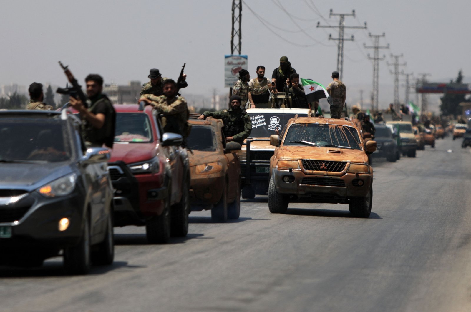 Turkish-backed Syrian opposition forces are pictured in the border town of Azaz in the opposition-held northern part of the Aleppo province, as they head toward an area facing the YPG-controlled town of Tal Rifaat, Syria, June 9, 2022. (AFP Photo)