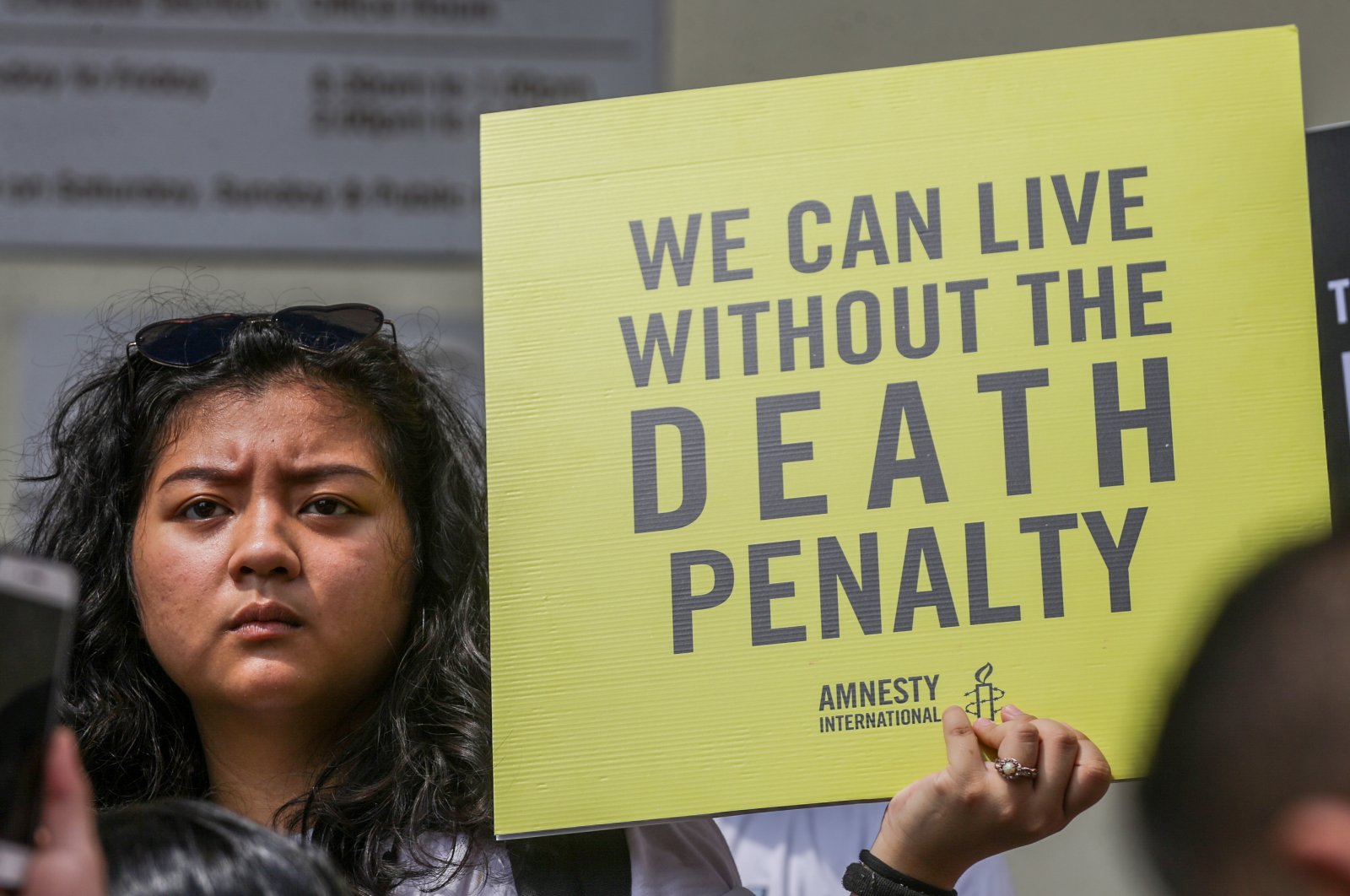 A woman holds a placard condemning death sentence during a protest in Kuala Lumpur, Malaysia, July 25, 2019. (ShutterStock Photo)
