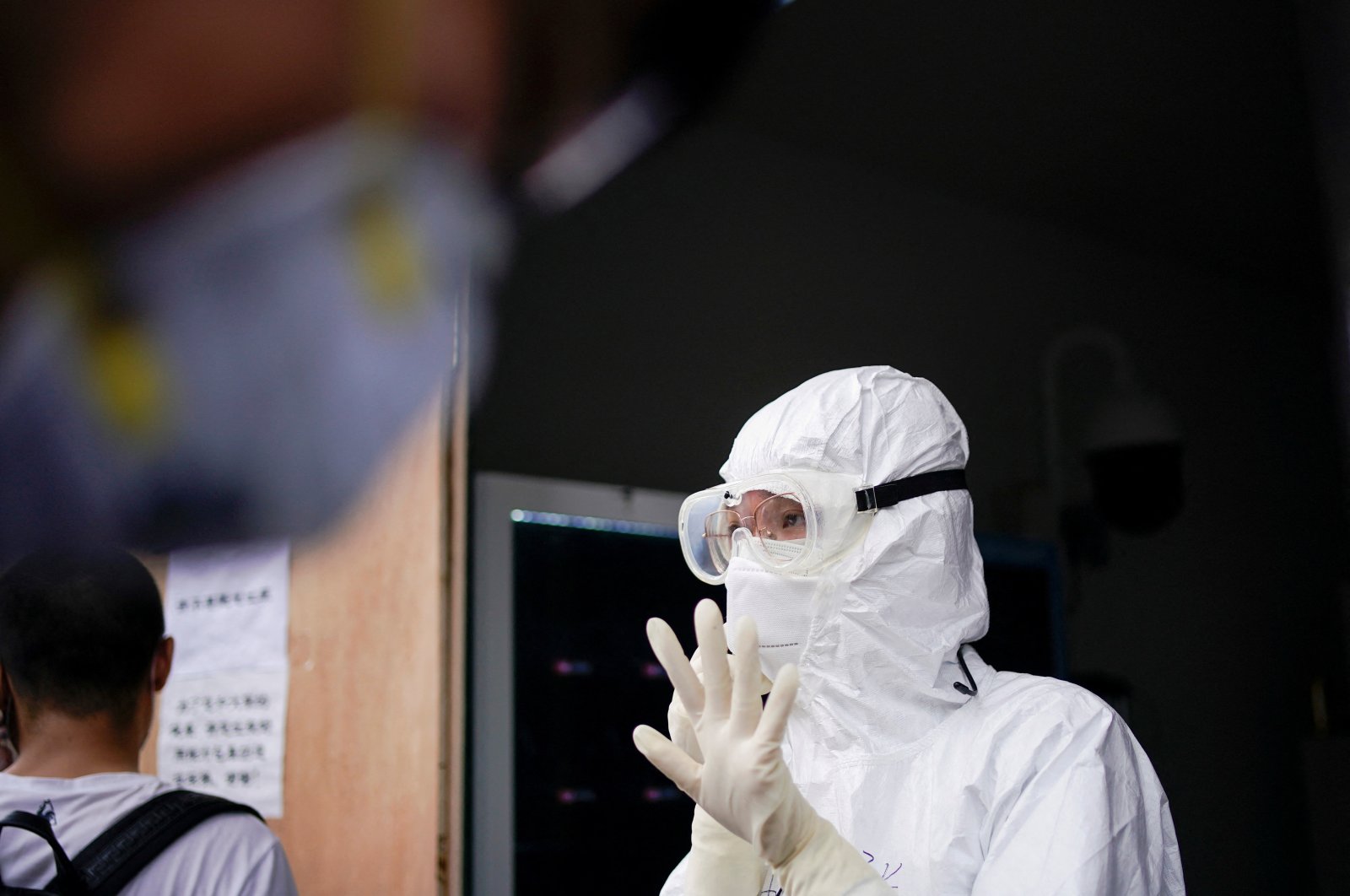 A health care professional gestures as residents line up for nucleic acid tests in Wuhan, the Chinese city hit hardest by the COVID-19 outbreak, Hubei province, China, May 16, 2020. (Reuters Photo)