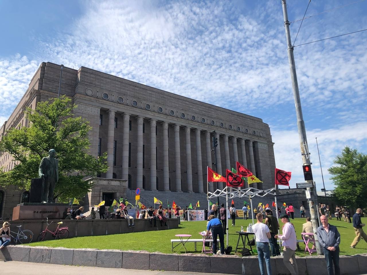 Despite the PKK being a proscribed terrorist group by the EU, terrorist supporters freely hold up PKK and YPG terrorist group symbols together in front of the Finnish parliament building and in Sweden today, further dispelling any arguments that the two are separate, Helsinki, Finland, June 11, 2022. (AA Photo)