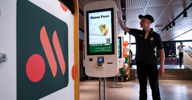 An employee cleans a self-ordering machine at the Russian version of a former McDonald's restaurant before the opening ceremony, Moscow, Russia, June 12, 2022. (AFP Photo)