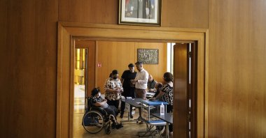 People vote in the first round of the French parliamentary election in Lyon, central France, Sunday, June 12, 2022. (AP Photo)