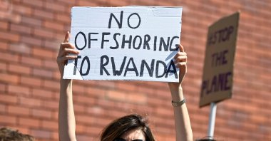 Demonstrators protest outside of an airport perimeter fence against the planned deportation of asylum-seekers from Britain to Rwanda, at Gatwick Airport near Crawley, Britain, June 12, 2022. (Reuters Photo)