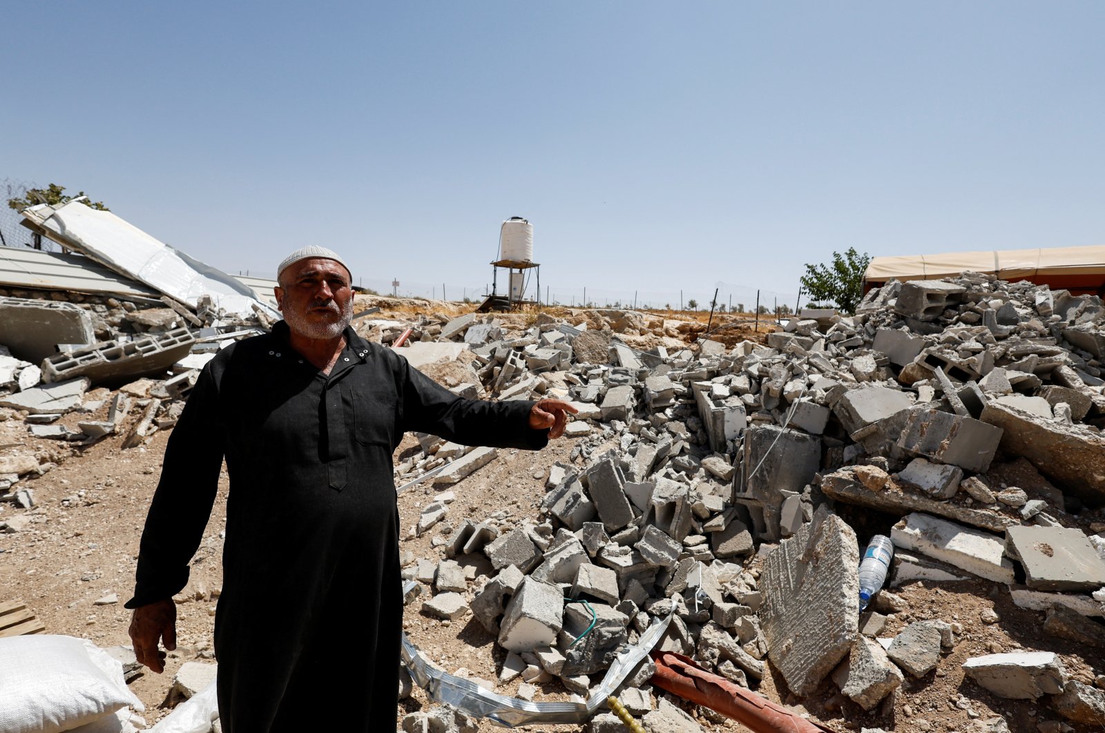 Palestinian Mahmoud Najajreh points at his demolished house, in Masafer Yatta, South of Hebron, in the Israeli-occupied West Bank, Palestine, May 31, 2022. (Reuters Photo)