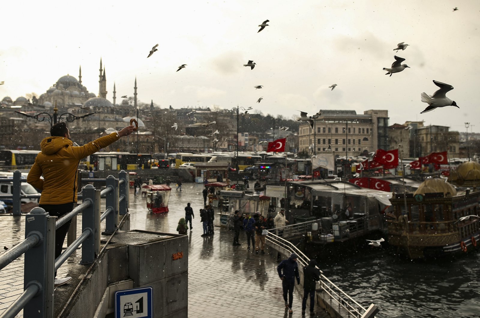 A man feeds seagulls in Eminönü in Istanbul, Turkey, March 10, 2022. (AP Photo)
