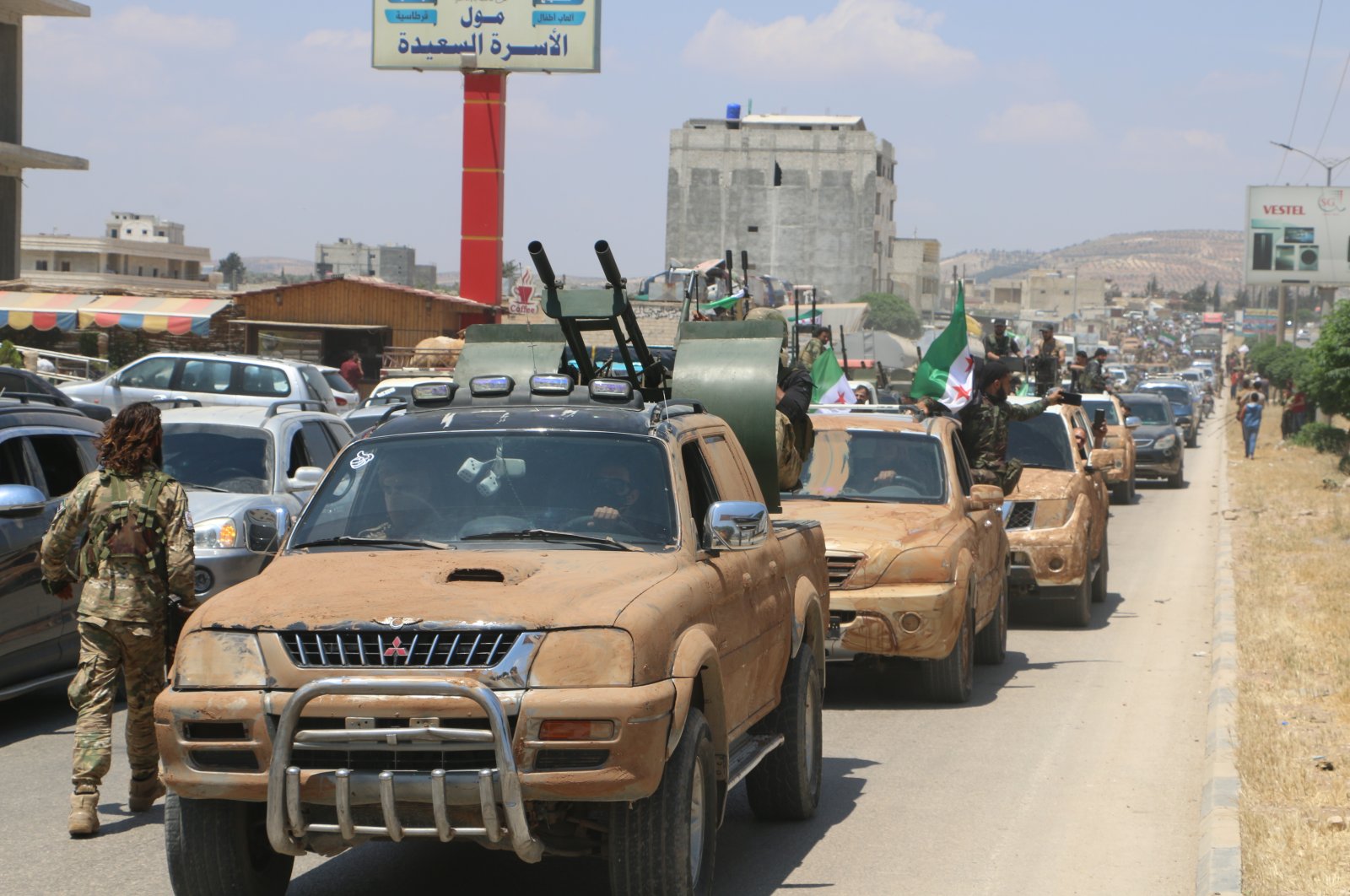 Turkey-backed opposition forces are pictured in the border town of Azaz as they head toward an area facing the town of Tal Rifaat, northern Syria, June 10, 2022. (Photo by Uğur Yıldırım)