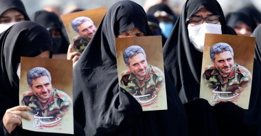 Iranian women lift portraits of Revolutionary Guards Col. Hassan Sayad Khodayari during his funeral procession at Imam Hussein Square, Tehran, Iran, May 24, 2022. (AFP Photo)