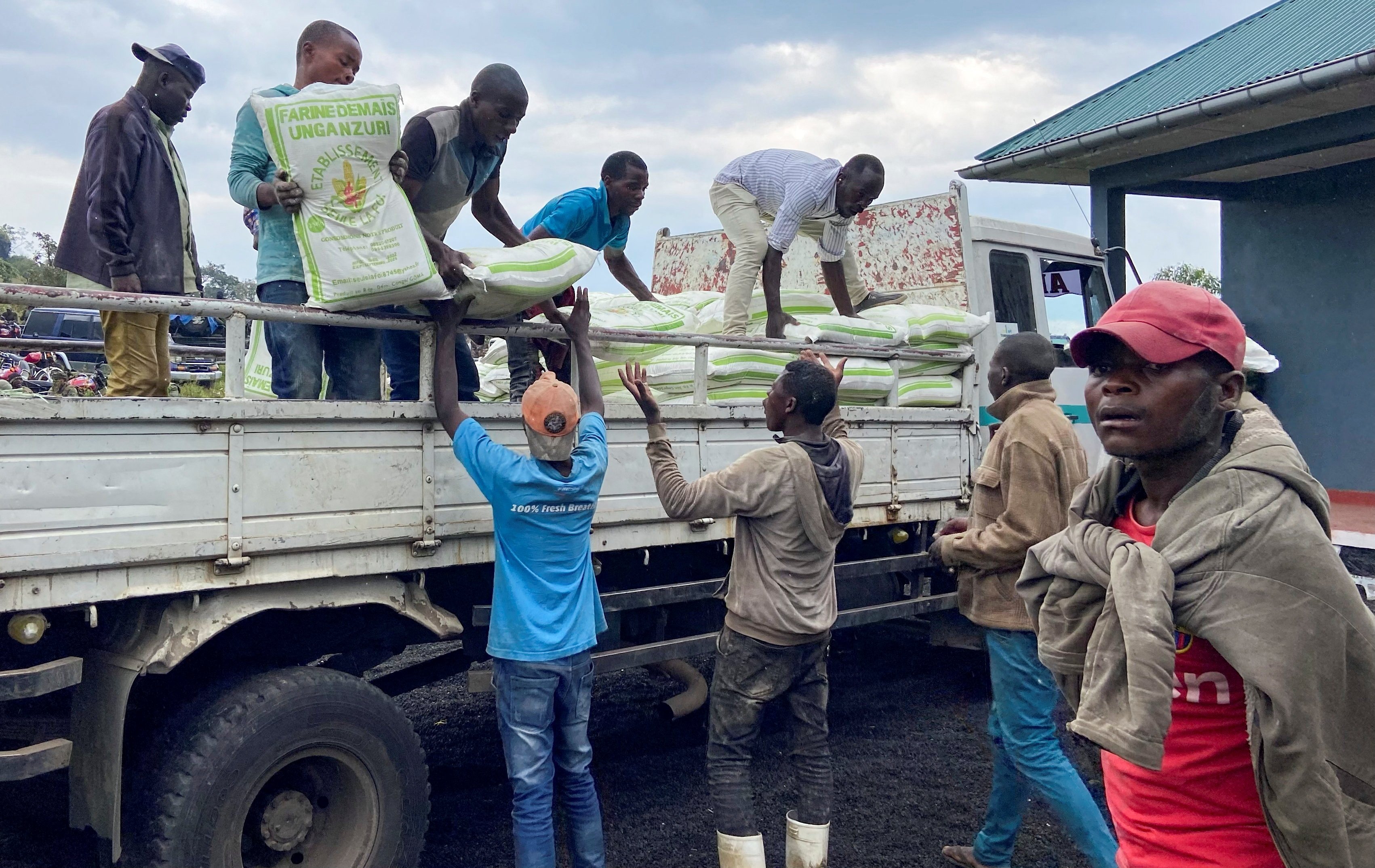 Civilians receive food aid given by the Armed Forces of the Democratic Republic of the Congo (FARDC) following renewed fighting in Kibumba, outside Goma in the North Kivu province of the Democratic Republic of Congo, June 9, 2022. (REUTERS PHOTO)