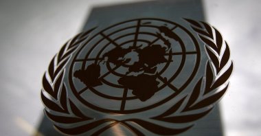 The United Nations headquarters building is pictured through a window with the U.N. logo in the foreground in the Manhattan borough of New York, U.S., Aug. 15, 2014. (Reuters Photo)