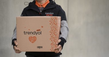 An employee of Turkish decacorn Trendyol holds a package in this undated file photo. (Courtesy of Trendyol)