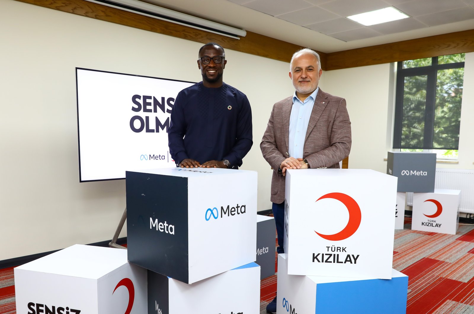 Turkish Red Crescent&#039;s (Kızılay) Dr. Kerem Kınık (R) and Meta executive Kojo Boakye pose at the launch of the tool, Istanbul, June 14, 2022. (Courtesy of the Turkish Red Crescent)