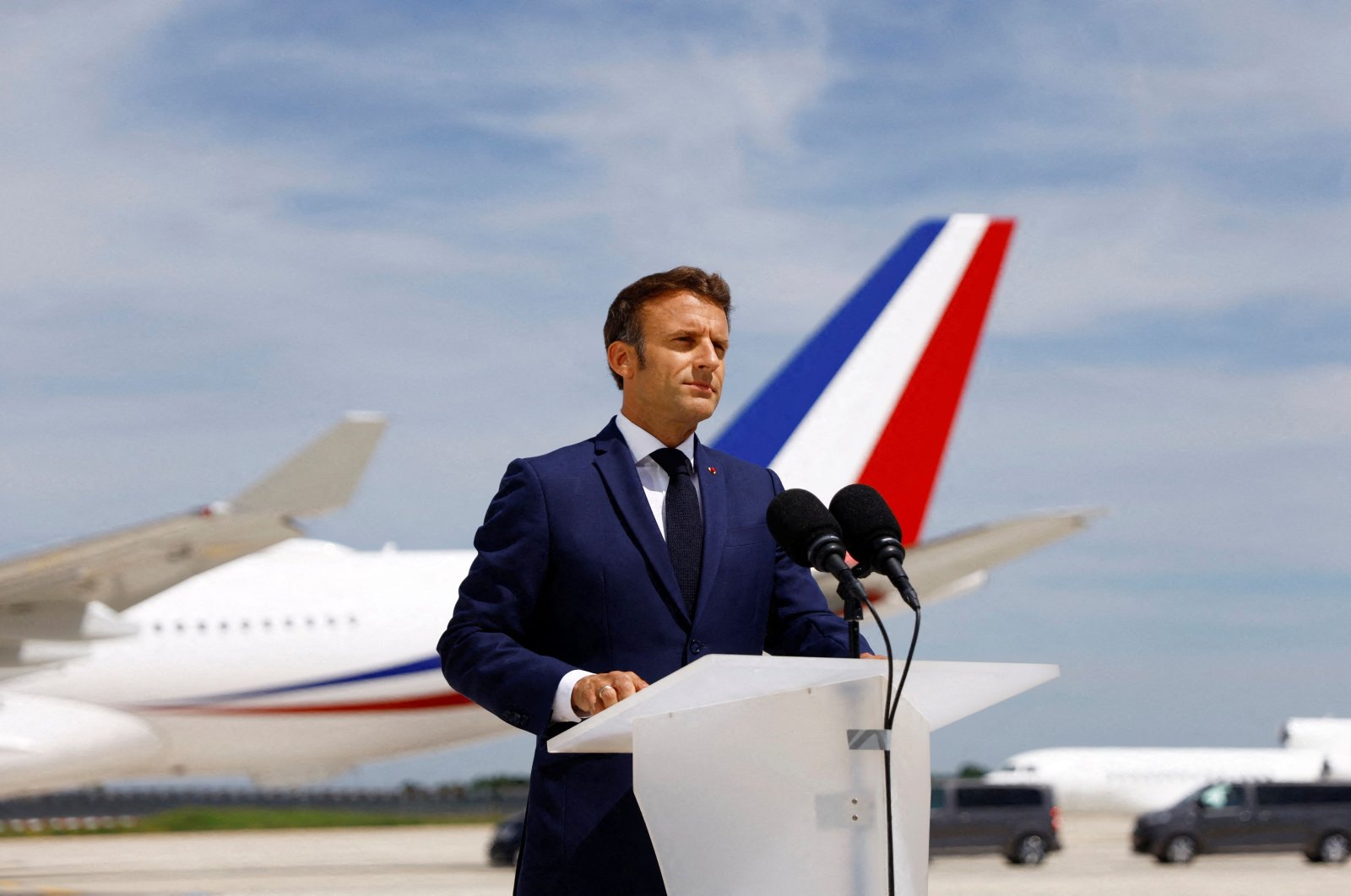 French President Emmanuel Macron delivers a statement on the tarmac before his departure to visit French NATO troops in Romania, at Paris-Orly Airport, Orly, France, June 14, 2022. (AFP Photo)