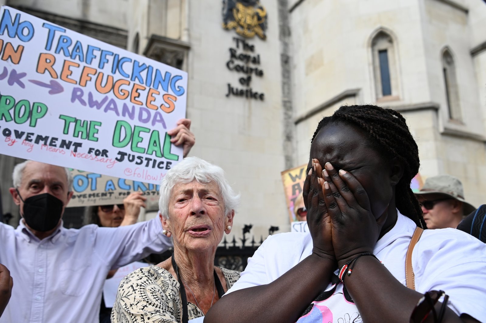 Human rights campaigners react after losing an appeal outside the High Court in London, Britain, June 13, 2022. (EPA)