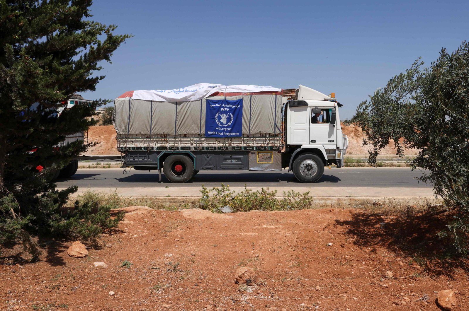A truck carrying aid packages from the World Food Programme (WFP) drives through the town of Saraqib in the northwestern Idlib province, Syria, June 12, 2022. (AFP Photo)