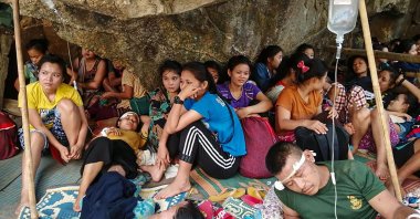 Karen villagers, injured during airstrikes in the area following the February military coup, rest after receiving medical treatment while taking shelter in a jungle near Day Pu No in Hpa-pun in eastern Karen state, Myanmar, March 30, 2021. (Free Burma Rangers via AFP)