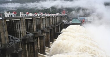 Water flows out from a gate of the Shuikou Hydropower Station in southeastern China's Fujian province, June 13, 2022. (AP Photo)