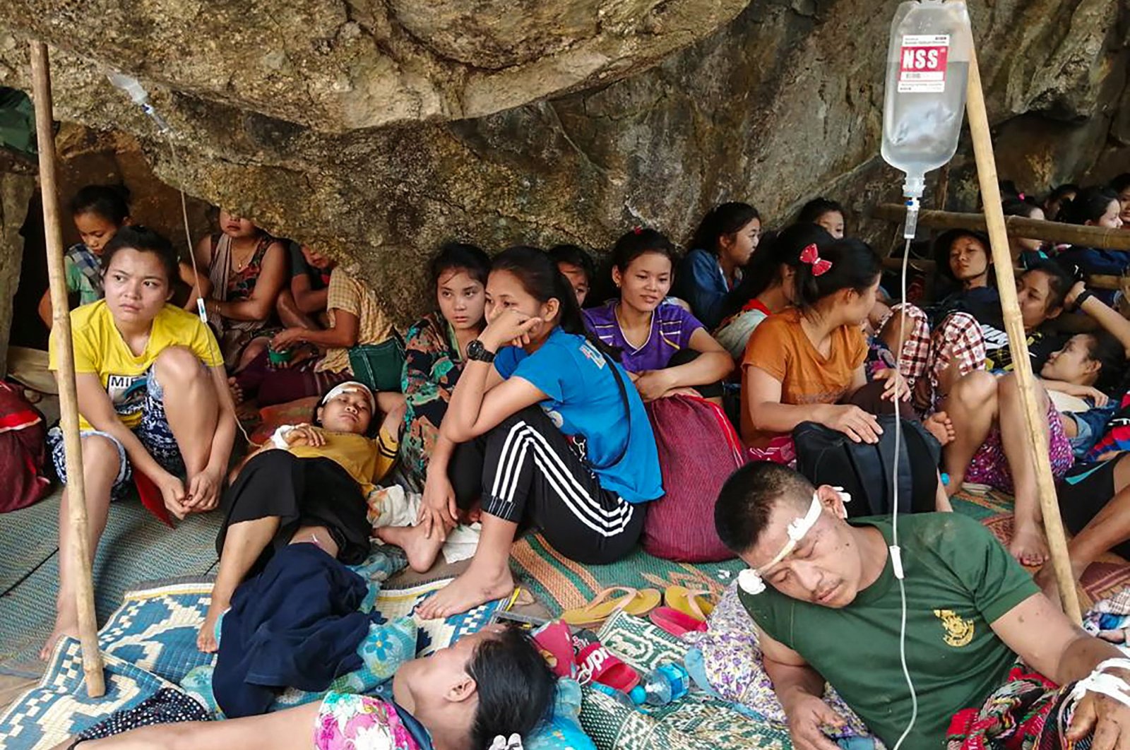 Karen villagers, injured during airstrikes in the area following the February military coup, rest after receiving medical treatment while taking shelter in a jungle near Day Pu No in Hpa-pun in eastern Karen state, Myanmar, March 30, 2021. (Free Burma Rangers via AFP)
