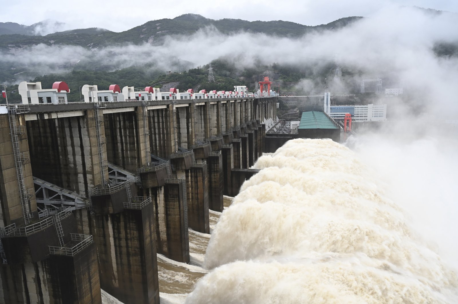 Water flows out from a gate of the Shuikou Hydropower Station in southeastern China&#039;s Fujian province, June 13, 2022. (AP Photo)