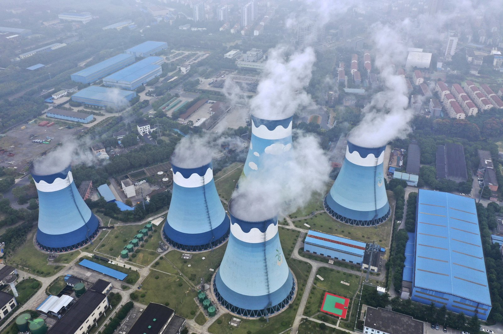 Steam billows out of the cooling towers at a coal-fired power station in Nanjing, Jiangsu province, eastern China, Sept. 27, 2021. (AP Photo)