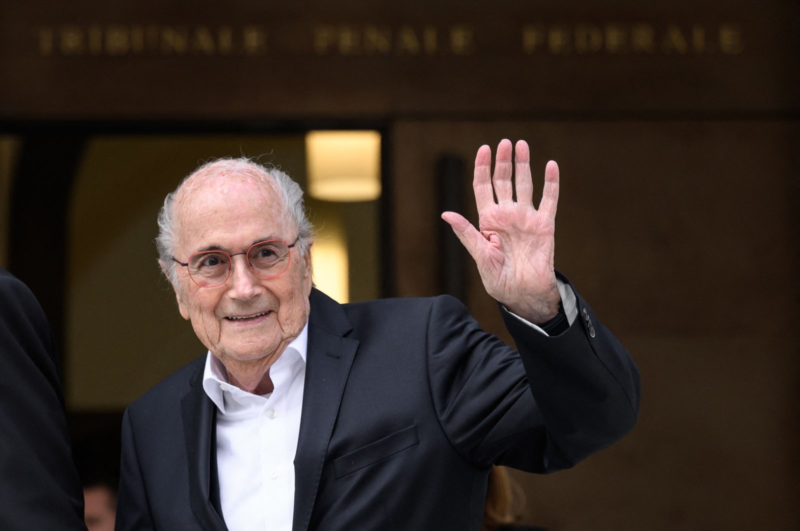 Former FIFA president Sepp Blatter waves to journalists as he leaves Switzerland&#039;s Federal Criminal Court, Bellinzona, Switzerland, June 8, 2022. (AFP Photo)