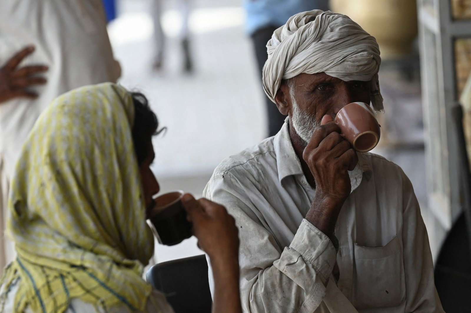 Men drink a cup of tea at a roadside restaurant in Islamabad, Pakistan, June 15, 2022. (AFP Photo)