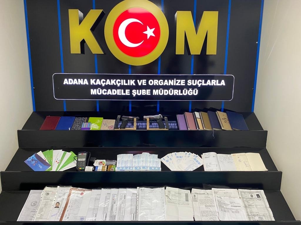 Police display forged documents and other items seized from suspects in the southern province of Adana, June 16, 2022. (AA PHOTO)