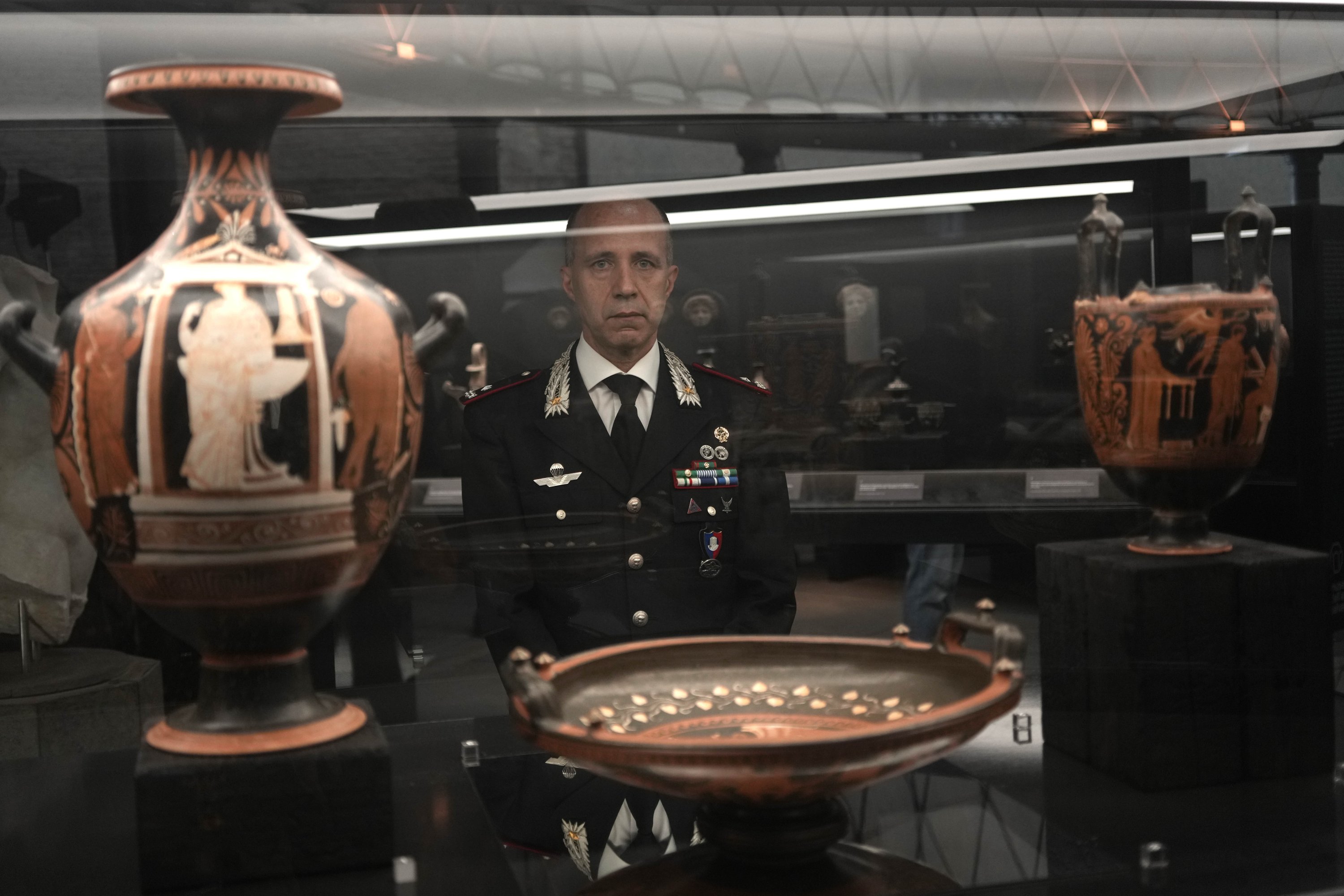 General Roberto Riccardi, head of the Carabinieri unit for the protection of cultural heritage looks at archaeological artifacts displayed in the new 