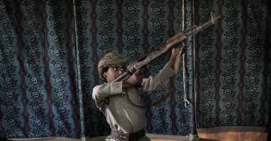 Kahlan, a 12-year-old former child soldier, demonstrates how to use a weapon, at a camp for displaced persons where he took shelter with his family, in Marib, Yemen, July 27, 2018. (AP Photo)