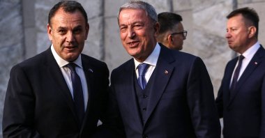 Defense Minister Hulusi Akar (R) and Greece's Defense Minister Nikolaos Panagiotopoulos shake hands as they pose for an official photo on the second day of a North Atlantic Treaty Organization (NATO) Defence Ministers' meeting at the NATO headquarters in Brussels, Belgium on June 16, 2022. (Photo by Valeria Mongelli / AFP)