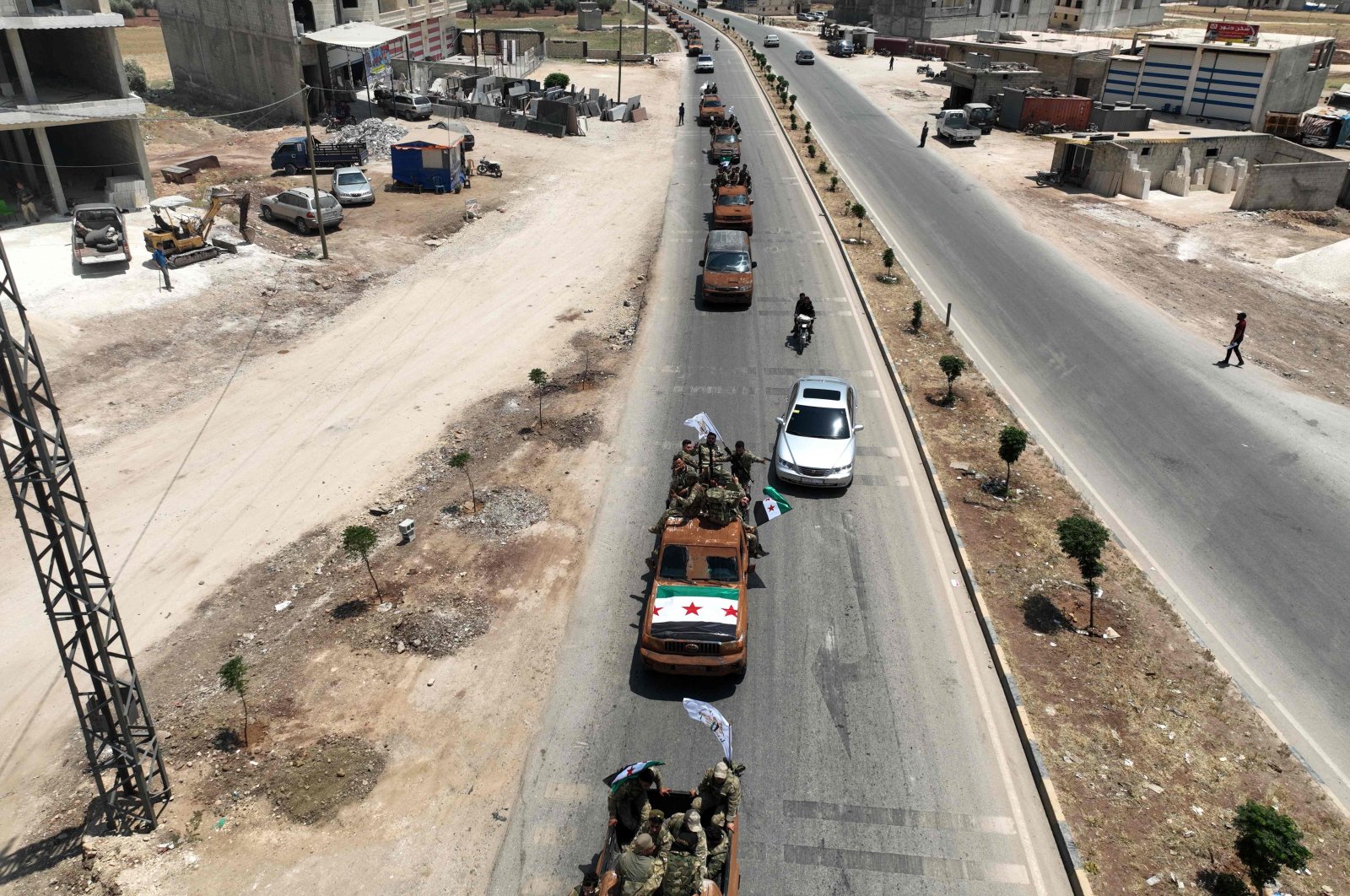 This aerial view shows Turkish-backed Syrian opposition groups in the border town of Azaz as they head toward an area facing the YPG-controlled town of Tal Rifaat, northern Syria, June 9, 2022. (AFP Photo)