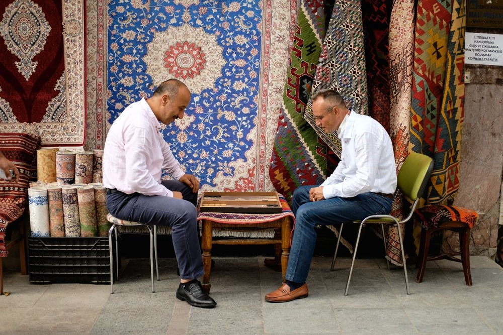Two male rug traders are playing backgammon on the street of Istanbul, Turkey, Sept. 25, 2020.