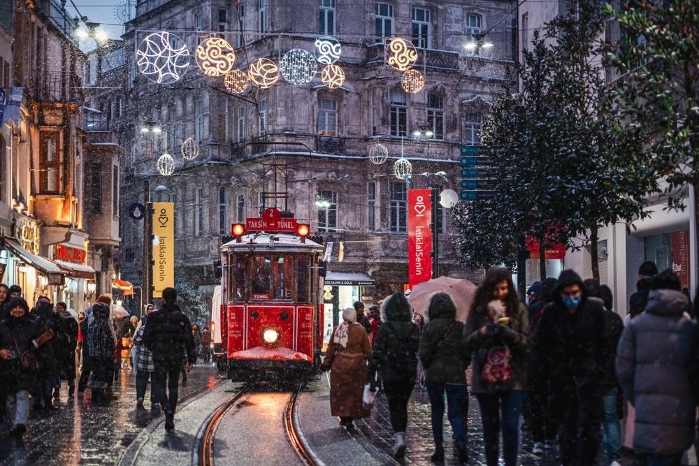 Red nostalgic tram is moving on the Istiklal street in Beyoğlu in a winter day, Istanbul, Turkey, March 11, 2022. (Shutterstock Photo) 