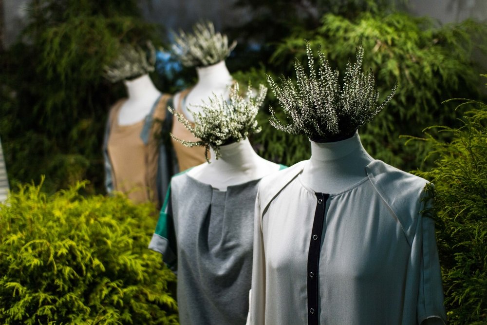 White mannequins , with heather on a dark green forest background. (Shutterstock Photo)