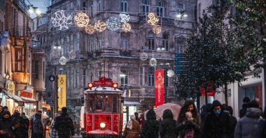 Red nostalgic tram is moving on the Istiklal street in Beyoğlu in a winter day, Istanbul, Turkey, March 11, 2022. (Shutterstock Photo) 