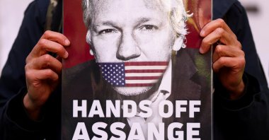 A supporter of Julian Assange displays a placard, outside the Westminster Magistrates&#039; Court in London, U.K., April 20, 2022. (Reuters Photo)