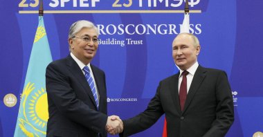 Russian President Vladimir Putin (R) and Kazakh President Kassym-Jomart Tokayev shake hands prior to their talks on the sidelines of the St. Petersburg International Economic Forum, St. Petersburg, Russia, June 17, 2022. (TASS Host Photo Agency Pool via AP)