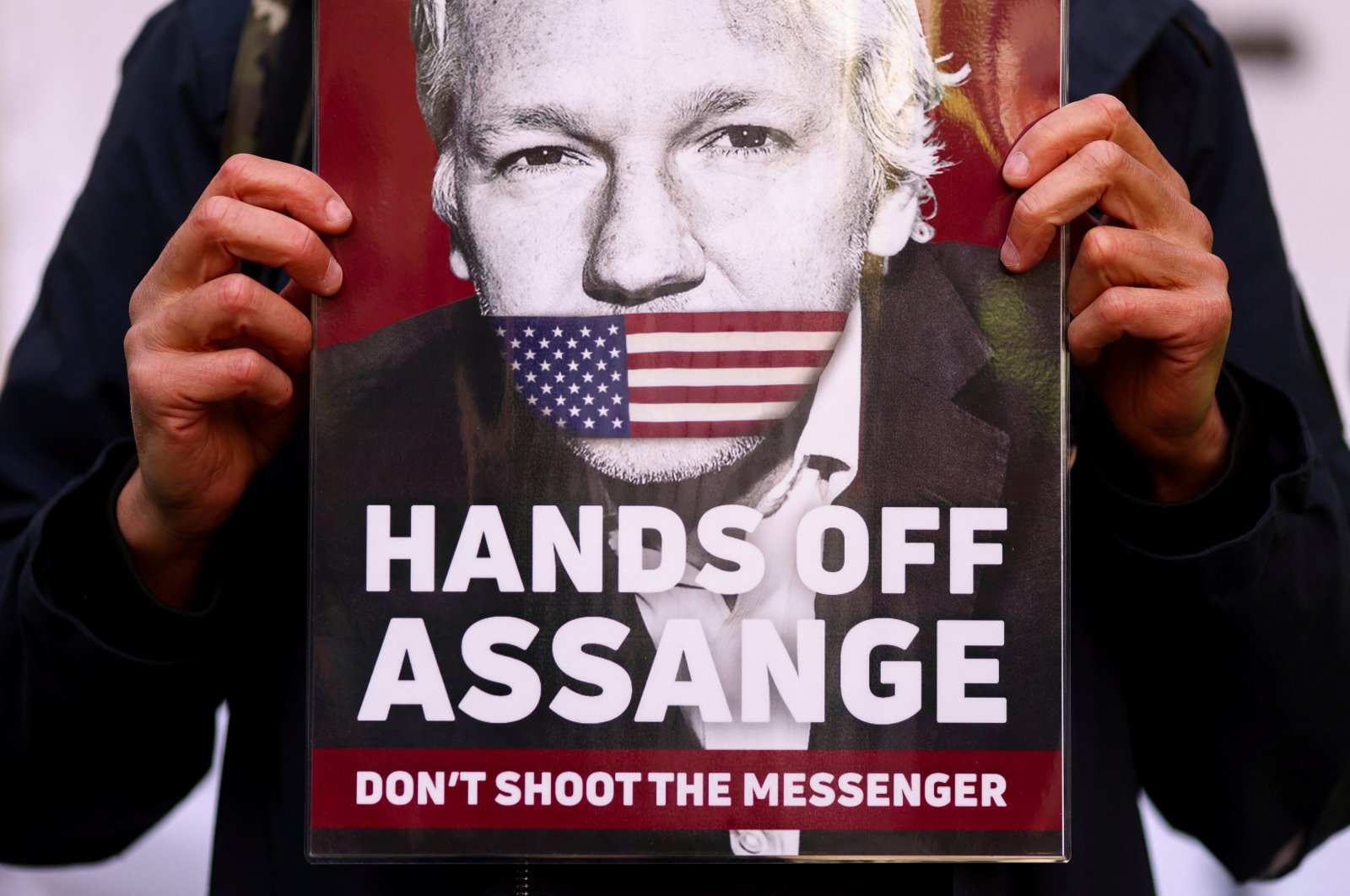 A supporter of Julian Assange displays a placard, outside the Westminster Magistrates&#039; Court in London, U.K., April 20, 2022. (Reuters Photo)