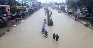 People wade through flooded waters in Sylhet, Bangladesh, June 18, 2022. (AP Photo)