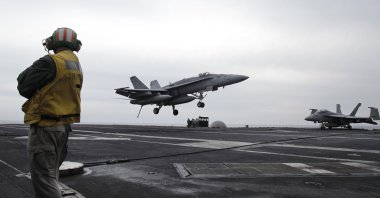 U.S. fighter jet lands on the USS Abraham Lincoln aircraft carrier during exercises in the Persian Gulf., U.S., Feb. 13, 2012. (AP Photo)