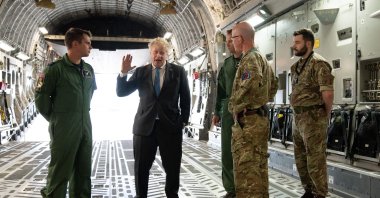 Britain's Prime Minister Boris Johnson (2nd L) speaks to Air Loadmaster 99 Squadron Sergeant Tom Clare (L), Officer Commanding 99 Squadron Wing commander Will Essex and officer commanding operations wing at RAF Brize Norton Wing commander Andy Hampshire on board a C17, after arriving at RAF Brize Norton, west of London having returned from Kyiv in Ukraine, June 18, 2022. (AFP Photo)