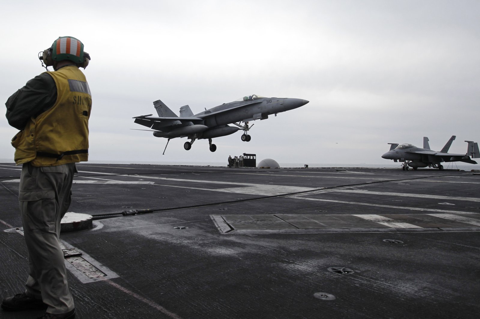 U.S. fighter jet lands on the USS Abraham Lincoln aircraft carrier during exercises in the Persian Gulf., U.S., Feb. 13, 2012. (AP Photo)