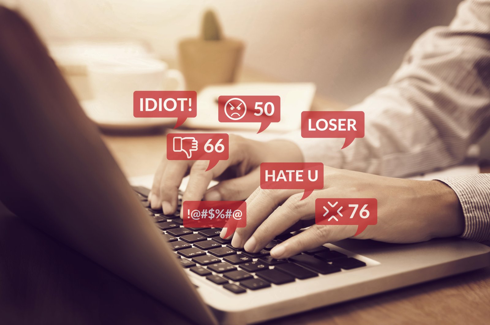 A cyberbully uses a laptop for social media interactions full of hate speech and negative comments. (Alamy via Reuters)