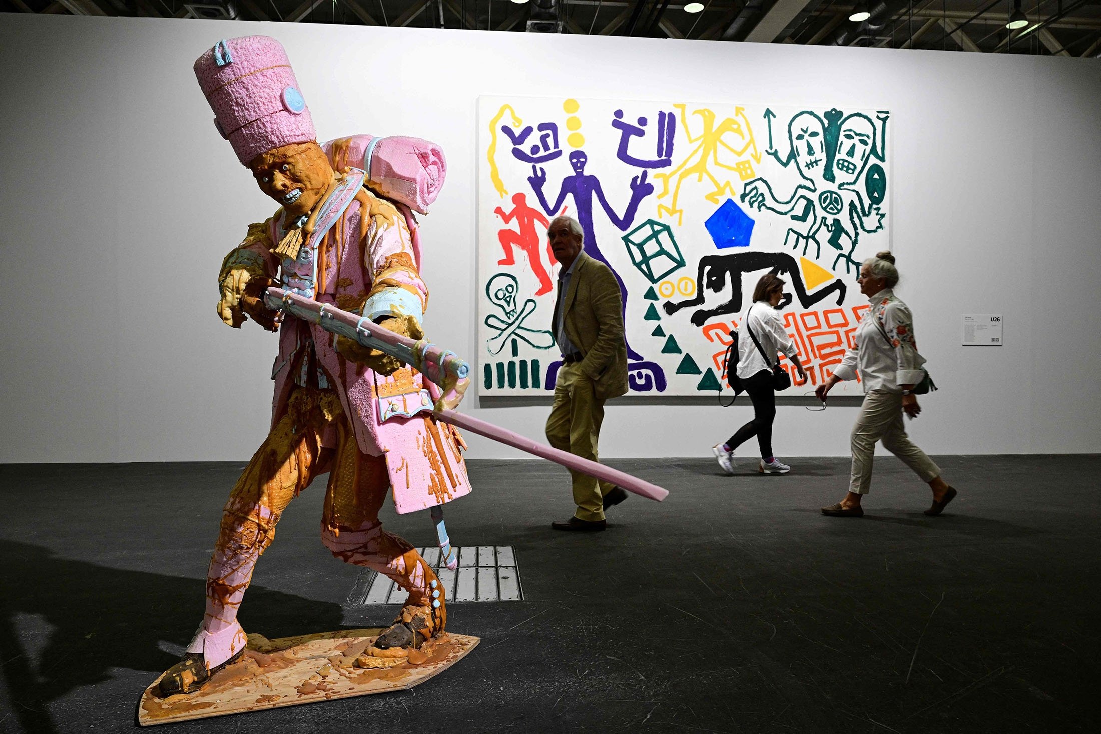 Visitors pass by a Folkert de Jong's artwork "The shooting… 1st July 2006" during a preview day of Art Basel, the world's premier modern and contemporary art fair in Basel, Switzerland, June 14, 2022. (AFP Photo)
