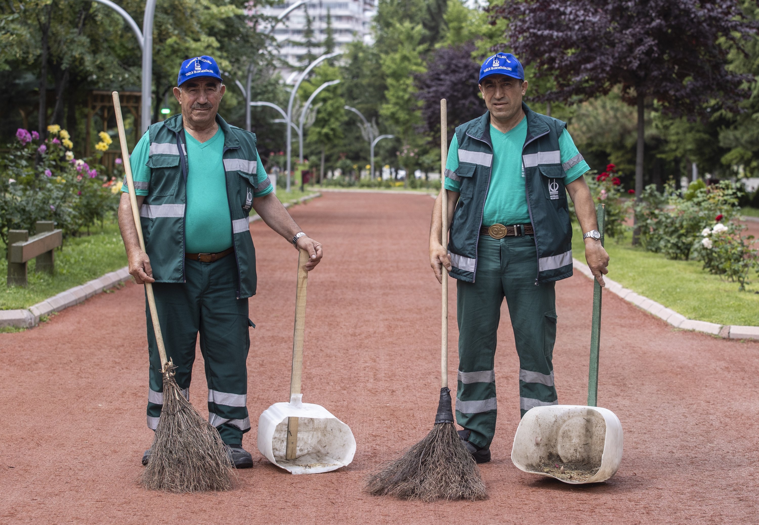 Father Yunus Şimşek (L) and his son Sami clean a park in the capital Ankara, Turkey, June 18, 2022. (AA Photo)