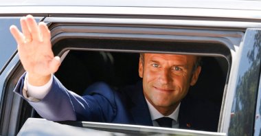French President Emmanuel Macron waves as he votes in the first round of French parliamentary elections, at a polling station in Le Touquet, France, June 12, 2022. (Reuters Photo)