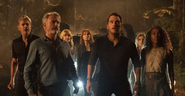 From left, Jeff Goldblum, Sam Neill, Laura Dern, Bryce Dallas Howard, Chris Pratt, Isabella Sermon and DeWanda Wise in a scene from the film &quot;Jurassic World: Dominion.&quot; (Universal Pictures via AP)
